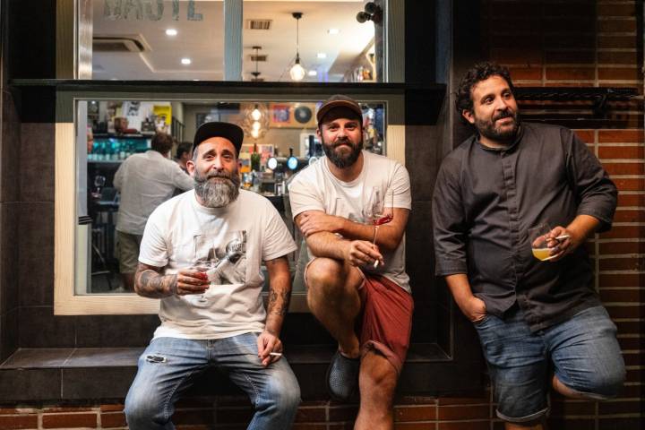 Álvaro, Raúl y Adrián apoyados por fuera en la pared de la taberna.