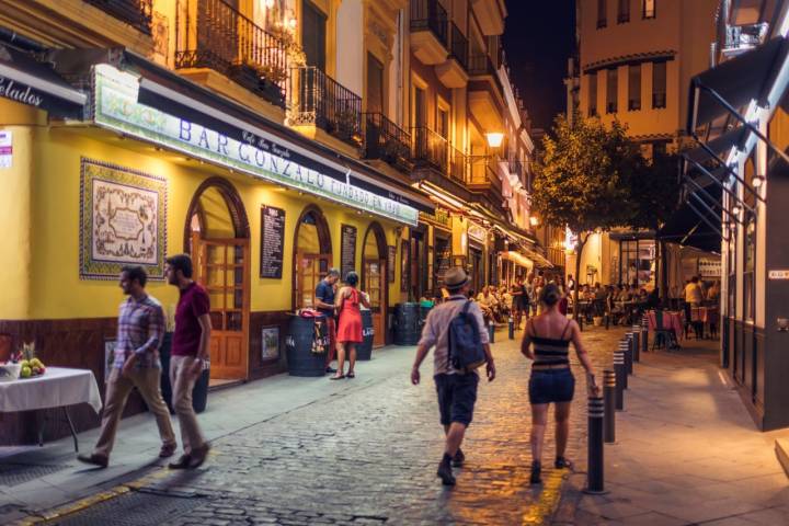 People out in the evening in the popular historical Santa Cruz neighborhood in Seville, Spain.