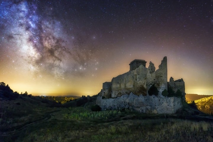 Night view of the ruins of Ucero castle, Soria, with the milky way in a clear sky