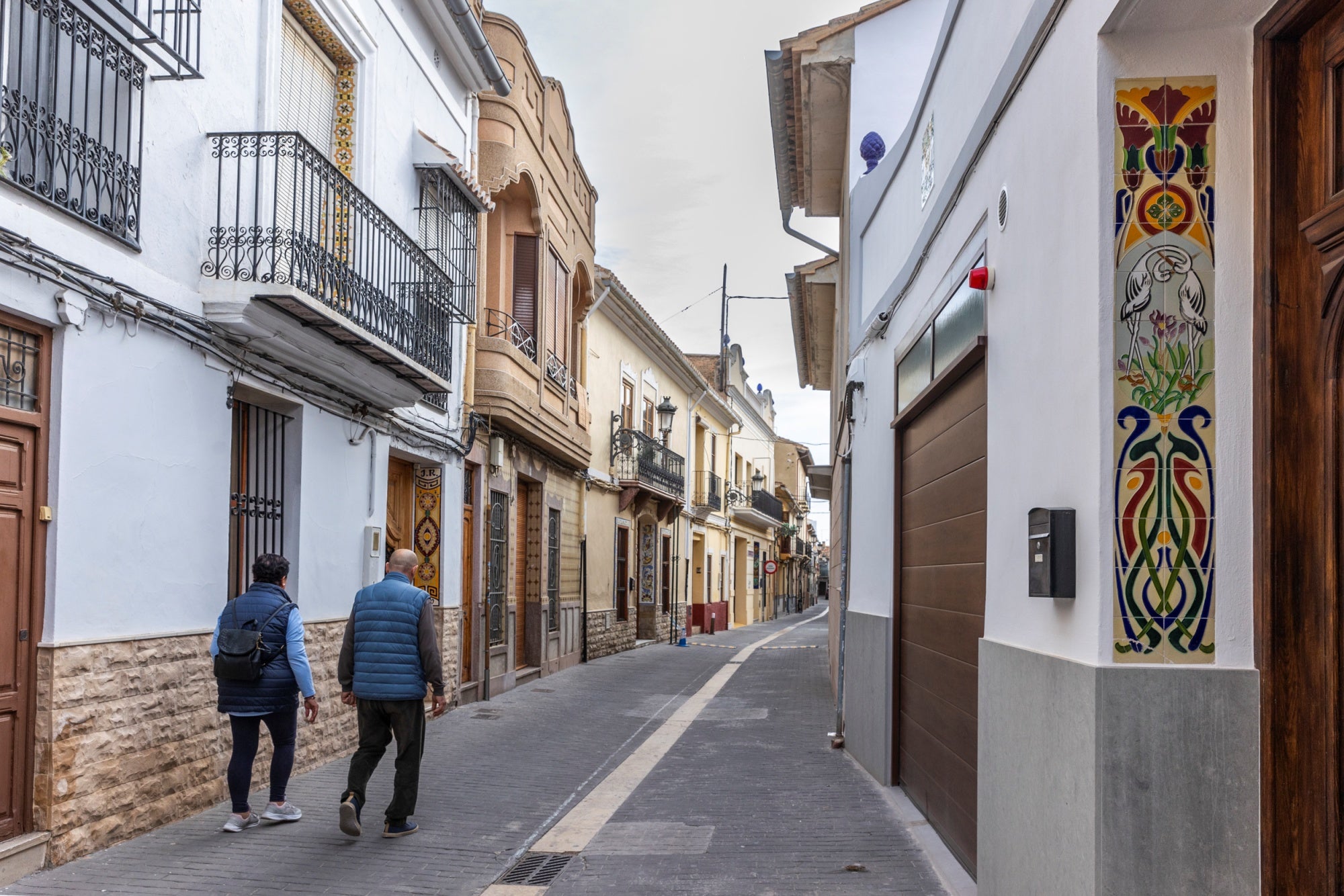 Vecinos paseando por una calle de Manises.