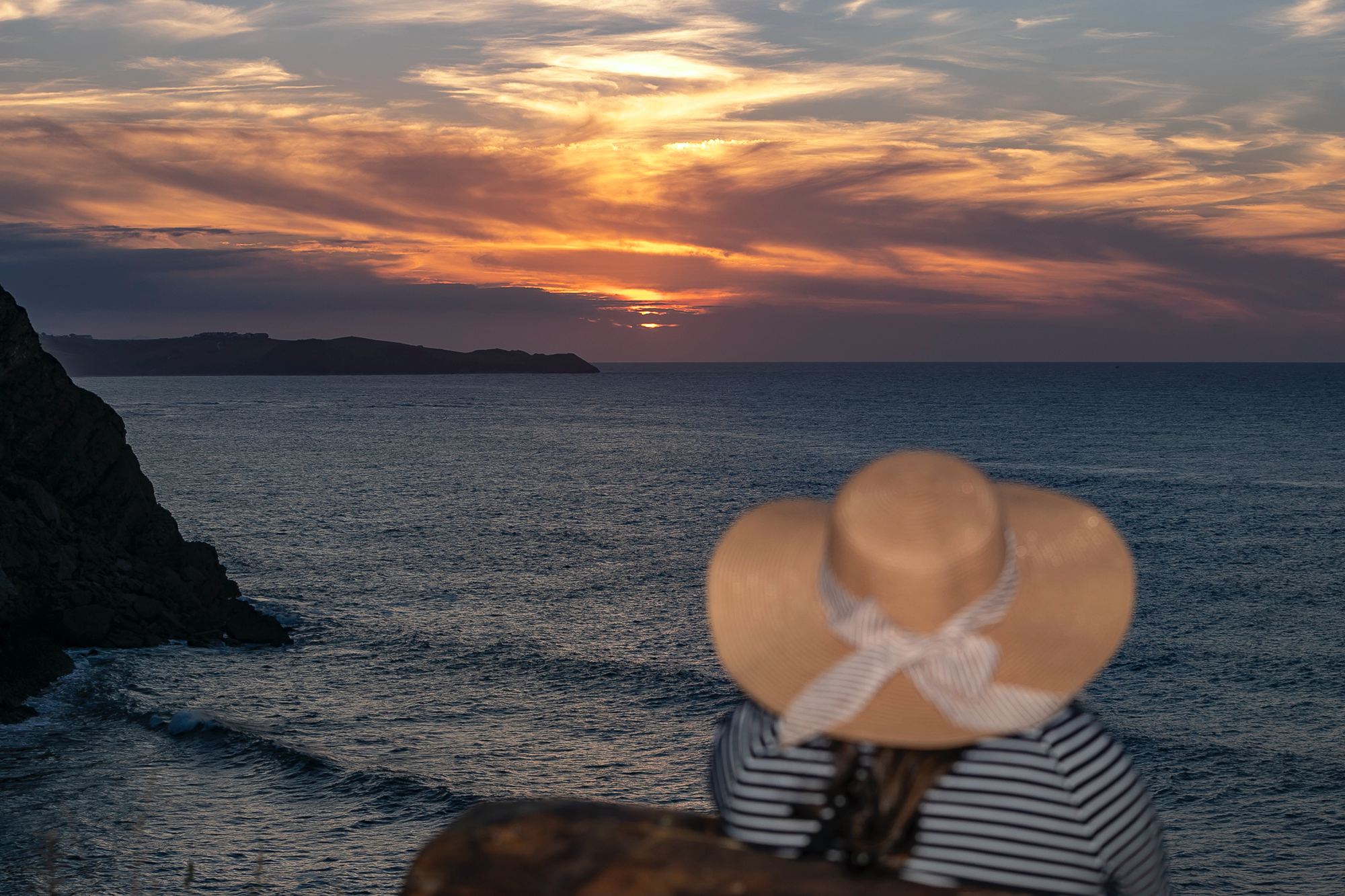 Una mujer contempla el atardecer desde el Mirador de La Corneja en Ruilobuca.